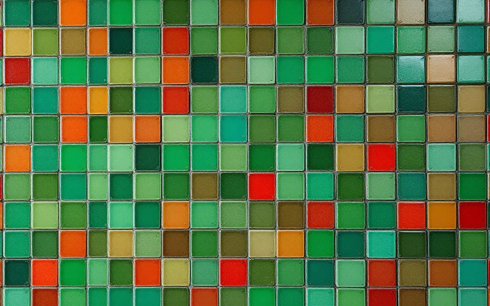 A grid of small coloured tiles filling the frame edge to edge, some green some red, flat even light, shot straight on, no writing or numbers anywhere