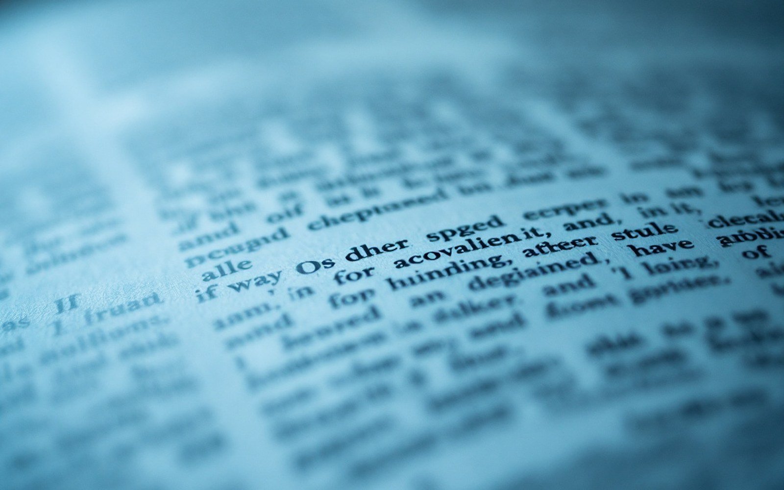 Macro on a single printed page, one line of small type sharp, the rest falling out of focus